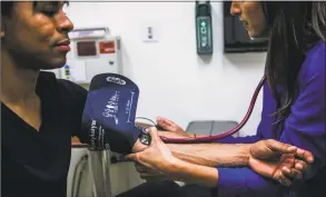  ?? Gabrielle Lurie / Special to San Francisco Chronicle ?? A patient has his blood pressure checked.