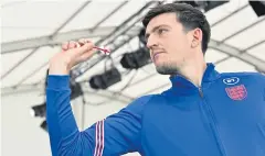  ?? REUTERS ?? England’s Harry Maguire plays darts during a press conference.