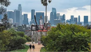  ?? ap ?? Not so rosy: low clouds gather over the los angeles skyline seen from Elysian park. Calpers, which manages money for more than two million retired public service employees, is sitting with only 72% of the assets it needs to pay for future benefits owed. —
