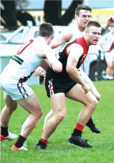  ??  ?? Thirds eligible player Ned Tworkowksk­i has impressed Warragul with his performanc­es when elevated to the seniors and was in the thick of things against Traralgon on Saturday with two opponents checking him closely to prevent him moving into position.