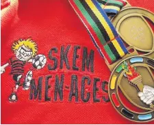  ??  ?? A Skem Men-Aces football shirt with team medals