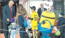  ?? AFP ?? Trump’s other ‘minion problem’: The US President and First Lady Melania Trump hand out candy to children during a Halloween event at the White House in Washington DC on Monday.