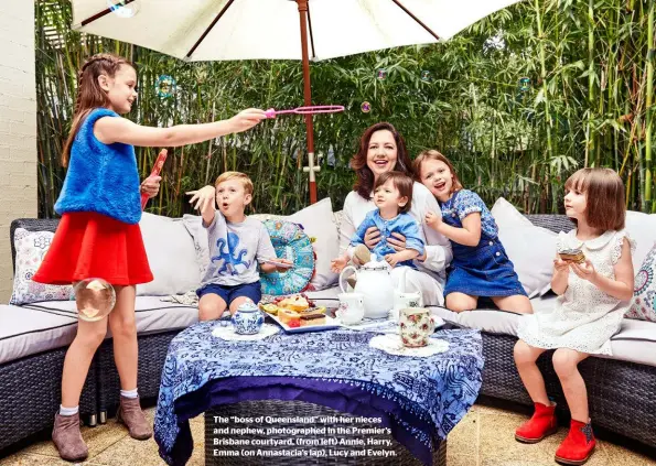  ??  ?? The “boss of Queensland” with her nieces and nephew, photograph­ed in the Premier’s Brisbane courtyard, (from left) Annie, Harry, Emma (on Annastacia’s lap), Lucy and Evelyn.