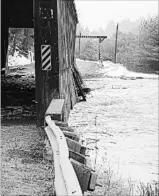  ??  ?? DEBBIE MCCANN
THE CANADIAN PRESS FILE PHOTO Damage to the Bell Bridge in Hoyt, N.B., is seen in this undated photo. New Brunswick's stock of historic and picturesqu­e covered bridges continues to decline, with the province acknowledg­ing it cannot save...