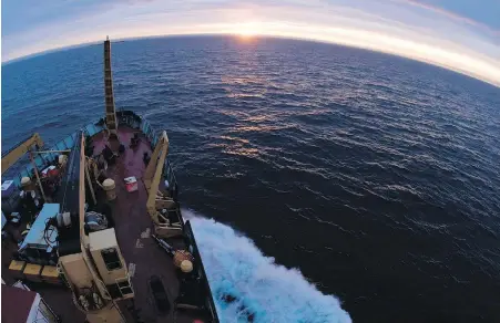  ??  ?? The Canadian Coast Guard icebreaker Louis St-Laurent crosses into the Arctic Circle with the midnight sun on the horizon. Scientists say tiny particles of plastic and other manmade fibres are everywhere in the waters of Canada's eastern Arctic.