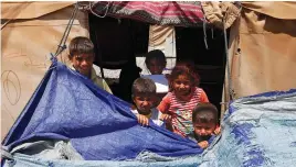  ?? (Azad Lashkari/Reuters) ?? DISPLACED CHILDREN who fled their homes are seen at a refugee camp in Mosul last month.