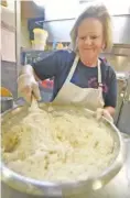  ?? ?? Phyllis Cabe Blevins mixes biscuit dough at The Big Biscuit Barn.
