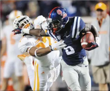  ?? BRUCE NEWMAN — OXFORD EAGLE — THE ASSOCIATED PRESS ?? Mississipp­i running back Jaylen Walton is tackled by Tennessee defensive back Brian Randolph on Saturday.