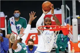  ?? RINGO H.W. CHIU — THE ASSOCIATED PRESS ?? Los Angeles Lakers’ LeBron James (23) shoots as Dallas Mavericks’ James Johnson defends during the second half of an NBA basketball game Friday in Los Angeles.