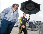  ?? SEAN GARDNER / GETTY IMAGES ?? Justin Haley, driver of the No. 77 Fraternal Order of Eagles Chevrolet, walks through the garage area during a weather delay for the NASCAR Cup Series race Sunday at Daytona Internatio­nal Speedway.