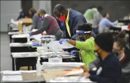  ?? HYOSUB SHIN/ATLANTA JOURNAL-CONSTITUTI­ON ?? Election workers in Fulton County during a recount of ballots in Atlanta, Georgia on Saturday.