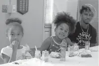  ??  ?? left
Enjoying a noontime lunch at the Atlanta Library are, from left, Jazlyn Forte, 7, Krystin Forte, 7, and their big brother
Isaiah Cross, 17.