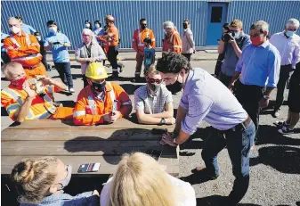  ?? THE CANADIAN PRESS ?? Liberal Leader Justin Trudeau speaks with workers at a steel plant in Welland, Ont., on Monday.