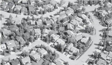  ??  ?? An aerial view of a Calgary subdivisio­n. A CIBC report said 47 per cent of all mortgages must be refinanced this year.