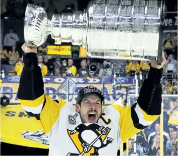  ?? BRUCE BENNETT/GETTY IMAGES ?? Pittsburgh Penguins’ captain Sidney Crosby celebrates with the Stanley Cup after they defeated the Nashville Predators 2-0 to win the 2017 NHL Stanley Cup Final at the Bridgeston­e Arena, on June 11, in Nashville, Tenn.