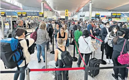  ?? ?? Waiting game: travellers queue to go through security at Heathrow Airport earlier this summer