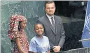  ?? AFP ?? Actor and climate activist Leonardo DiCaprio (right), with members of Indigenous Women and Peoples Associatio­n of Chad, at the United Nations Signing Ceremony for the Paris Agreement climate change accord in New York on Friday.