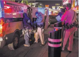  ?? Patrick Connolly ?? Las Vegas Review-journal @Pconnpie Metropolit­an Police Department officers with police volunteers and outreach agencies participat­ed in the Take Back the Las Vegas Strip event Friday to help individual­s and make the Strip safer.