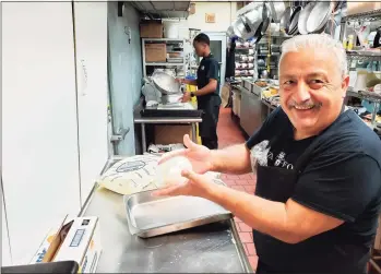  ?? Frank Whitman / For Hearst Connecticu­t Media ?? Angelo Competiell­o of Angelo’s Specialtie­s making fresh mozzarella.