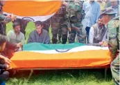  ?? — AP ?? Soldiers cover the coffin of their colleague Umar Fayaz with the Tricolour during his funeral at Sursoona village, near Srinagar on Wednesday.