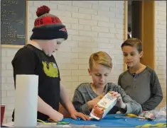  ??  ?? Above left: Chayse Lefler, Cyton Corsie and Caysh Corsie begin assembling their boat Saturday at the APEGA Science Olympics, held at Medicine Hat College.