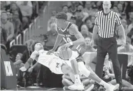  ?? JAE HONG/AP ?? Texas A&M forward Robert Williams, right, drives against Michigan guard Jordan Poole during the first half of their regional semifinal in Los Angeles on Thursday.