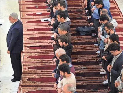  ?? PHOTOS BY DOUG HOKE/THE OKLAHOMAN ?? Imam Imad Enchassi, senior imam of the Islamic Society of Greater Oklahoma City, leads the Dhuhur Prayer on Monday during Muslim Day at the Oklahoma Capitol.