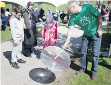  ?? PHOTOS: DAX MELMER ?? Klaus Dohring of Green Sun Rising shows off the power of the sun by using a Fresnel lens at Sunday’s Earth Day celebratio­n at Malden Park, hosted by the City of Windsor and the Solid Waste Authority.