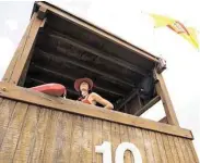  ?? Alysha Beck / For the Chronicle ?? Lifeguard Hannah Hall, 18, surveys Galveston’s Porretto Beach from a lifeguard tower. She went through two weeks of intense training to become a lifeguard with the Galveston Beach Patrol.