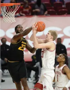  ?? NWA Democrat-Gazette/Andy Shupe ?? Arkansas forward Connor Vanover, right, has his shot blocked by Missouri forward Jeremiah Tilmon during the first half of Saturday’s game in Bud Walton Arena.