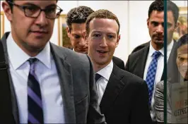  ?? ALEX WONG / GETTY IMAGES ?? Facebook CEO Mark Zuckerberg (third from left) leaves after a meeting Monday with U.S. Sen. Bill Nelson (D-Florida), ranking member of the Senate Committee on Commerce, Science, and Transporta­tion in Washington, DC. Zuckerberg is set to testify before...