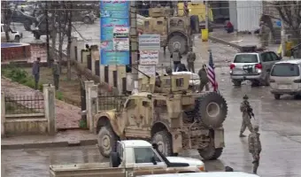  ?? GETTY IMAGES PHOTOS ?? DEADLY BLAST: Image grabs taken from a video Wednesday show, from top, U.S. troops gathered at the scene of a suicide attack in the northern Syrian town of Manbij, a member of Syrian security forces and people gathering at the scene.