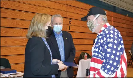  ?? RACHEL RAVINA - MEDIANEWS GROUP ?? U.S. Rep. Madeleine Dean, D-4th Dist., stands with her brother, Bob, left, as she gives a commendati­on to Vietnam-era veteran Fred Rainer, of Lansdale, Sunday morning during a COVID-19vaccinat­ion clinic at North Penn High School.