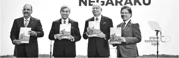  ??  ?? Najib (second right) with Ahmad Zahid (second left) show the NTP book. At left is Chief Secretary to the Government Tan Sri Dr Ali Hamsa while on the right is president and CEO of Pemandu Associates Sdn Bhd Datuk Seri Idris Jala. — Bernama photo