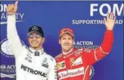  ?? AFP ?? Lewis Hamilton (left) celebrates after winning pole.