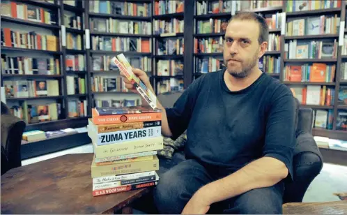  ?? PICTURE: ADRIAN DE KOCK ?? PAGE-TURNERS: Mervyn Sloman, the owner of the The Book Lounge, recommends The Blacks of Cape Town and Americanah, among others
