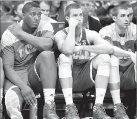  ?? Luis Sinco Los Angeles Times ?? UCLA’S JOSHUA SMITH, left, and the Wear twins, Travis and David, display the prevailing emotion on the bench at the end of the loss to Arizona.