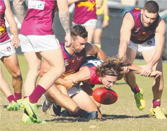  ??  ?? Surfers player Lachlan Anderson gets his head over the ball despite some close attention by PBC rival Tyler Cornish. Picture: MIKE BATTERHAM