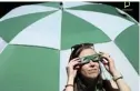  ?? Picture: ELOISA LOPEZ/REUTERS ?? RARE SIGHT: A patron uses special protective glasses to observe the total solar eclipse at the Augusta National Golf Club in Georgia yesterday