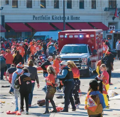  ?? REED HOFFMANN/AP ?? Police clear the area following Wednesday’s mass shooting at the Chiefs’ Super Bowl celebratio­n in Kansas City, Missouri. One person was killed and nearly two dozen were injured. The community is feelng a mix of emotions as it tries to process the day’s trauma.