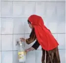  ??  ?? ISLAMABAD: A girl fills a bottle at a water filtration plant in Islamabad. More than two-thirds of households drink bacteriall­y contaminat­ed water and, every year, 53,000 Pakistani children die of diarrhea after drinking it, says UNICEF. —AFP