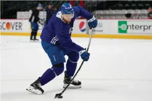  ?? The Associated Press ?? ■ Colorado Avalanche center Nathan Mackinnon (29) hits a shot during an NHL practice ahead of Game 2 of the Stanley Cup Finals Friday in Denver.