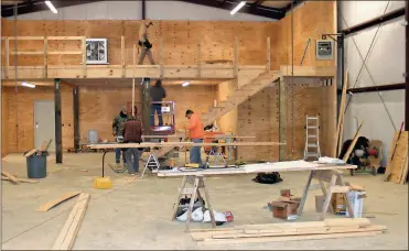  ?? / Doug Walker ?? Contractor­s work on the interior of the vehicle storage building for the Fisheries division at the new regional DNR headquarte­rs building on Floyd Springs Road. The new building is supposed to be ready for occupancy before Christmas.