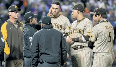  ?? N.Y. Post: Charles Wenzelberg; Getty Images ?? PROBE THE LOBE: Umpires check Joe Musgrove’s ears for foreign substances, at Buck Showalter’s request (above), during the sixth inning of the Mets’ 6-0 loss to the Padres.