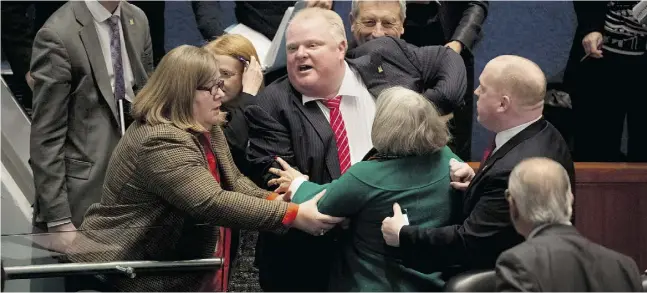  ?? Pete r J. Thompson / National Post FILES ?? Former mayor Rob Ford is restrained during a fiery meeting at Toronto City Hall in November 2013 that became “notorious” around the world.