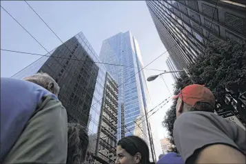  ?? MIKE KEPKA / SAN FRANCISCO CHRONICLE VIA AP ?? In 2010, bystanders watch as Dan Goodwin, aka Spider Dan, makes his way to the top of Millennium Tower in San Francisco. Officials want answers as to why the city’s building inspection department waited years to look into evidence of structural issues...