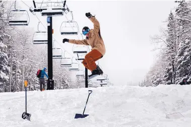  ?? EDDIE MOORE/JOURNAL ?? Blaine Thompson, 20, from Carlsbad, catches air on a jump he and others made at Ski Santa Fe after a snowfall on Nov. 22.