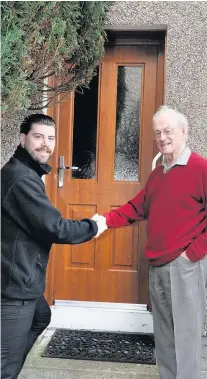  ??  ?? Happy Jason Lisett of Caledonian Windows with customer Keith Batley of Ayr outside his new backdoor