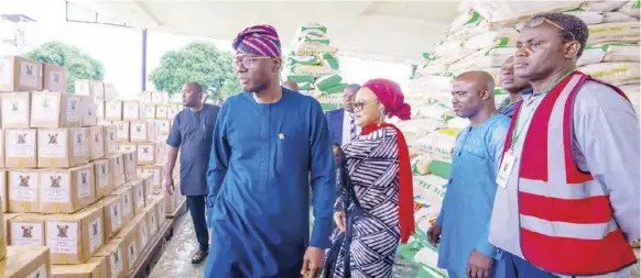  ?? ?? Governor of Lagos State Babajide Sanwo-Olu inspecting the foodboxes and packs during the official flag-off of the Lagos State government foodbank p-rogramme, as part of the palliative measures to mitigate the effect offuel subsidy removal, at the Lagos House, Alausa, Ikeja,in Lagos.PHOTO BY KOLAWOLE ALIU