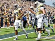  ?? HYOSUB SHIN / HYOSUB.SHIN@AJC.COM ?? Tech running back Jordan Mason (27), exulting after a TD against The Citadel last month, had his first 100-yard game against Duke.